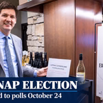David Eby beside a Buy Canadian display